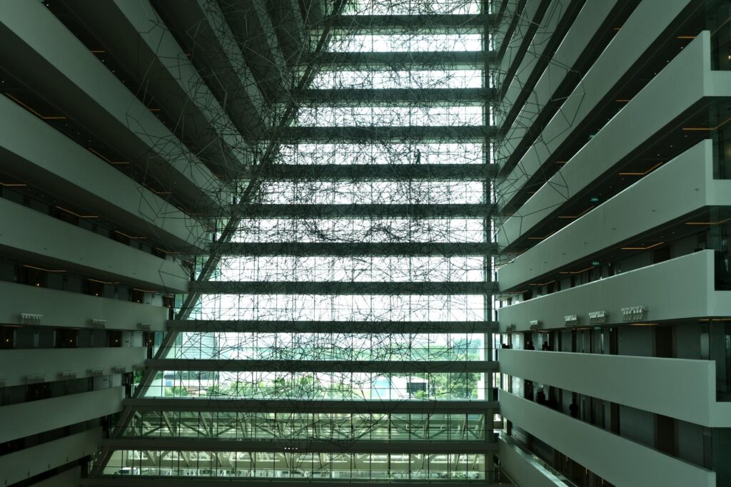 This photograph captures the expansive interior of a multi-story atrium, where levels of white balconies flank a massive central void.