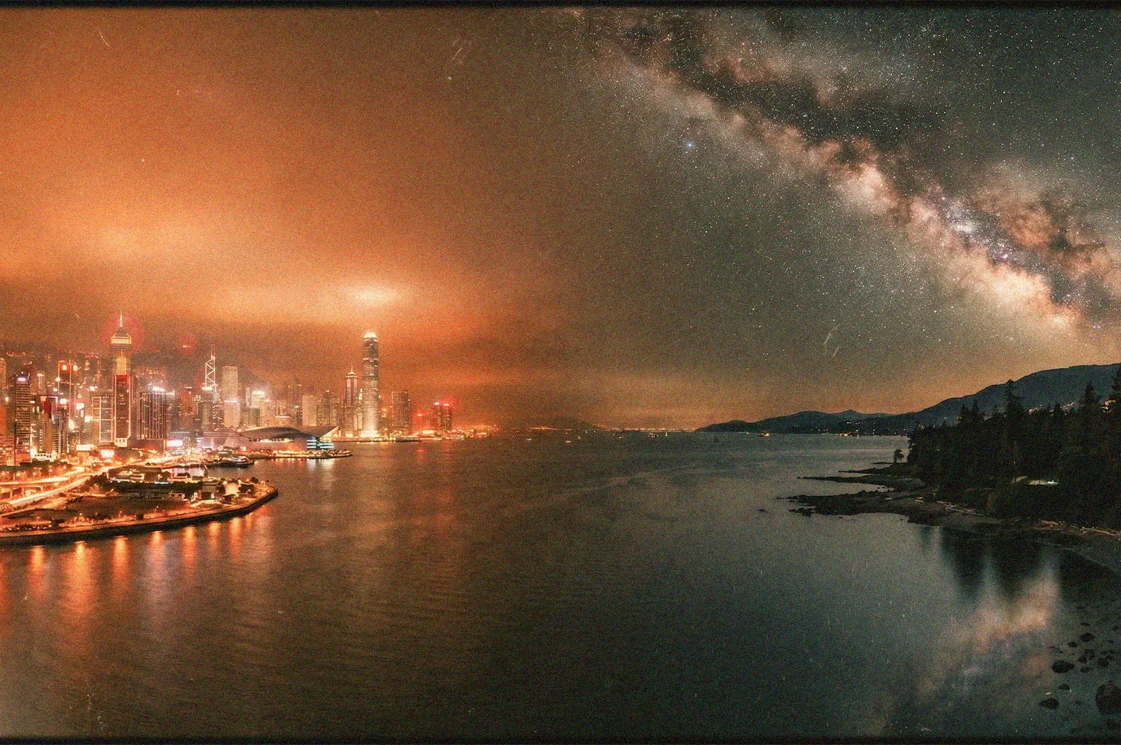 Split screen landscape showing the bright orange light pollution of the Hong Kong city skyline contrasted with a dark, starry Milky Way night sky over a natural coastline.