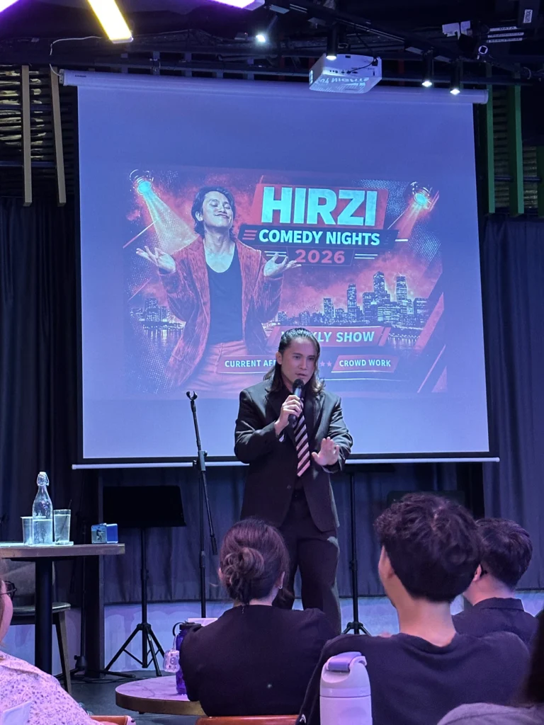 Comedian Hirzi performing live on stage at Hirzi Comedy Nights 2026 stand-up show.