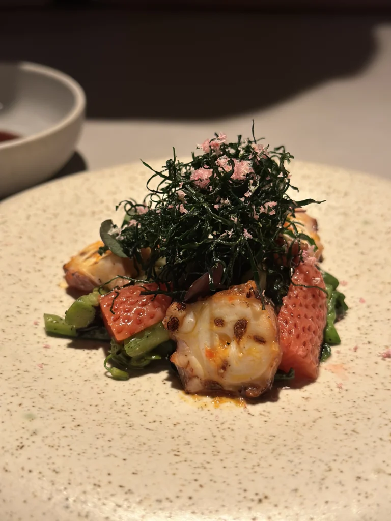Gourmet seafood soup with clams and herb oil drizzle at Belimbing restaurant.