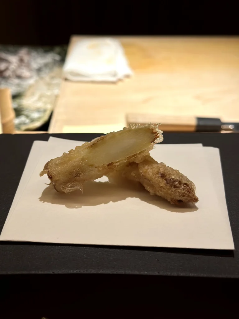 White asparagus tempura with a delicate golden coating, highlighting the vegetable’s tender texture and natural sweetness.