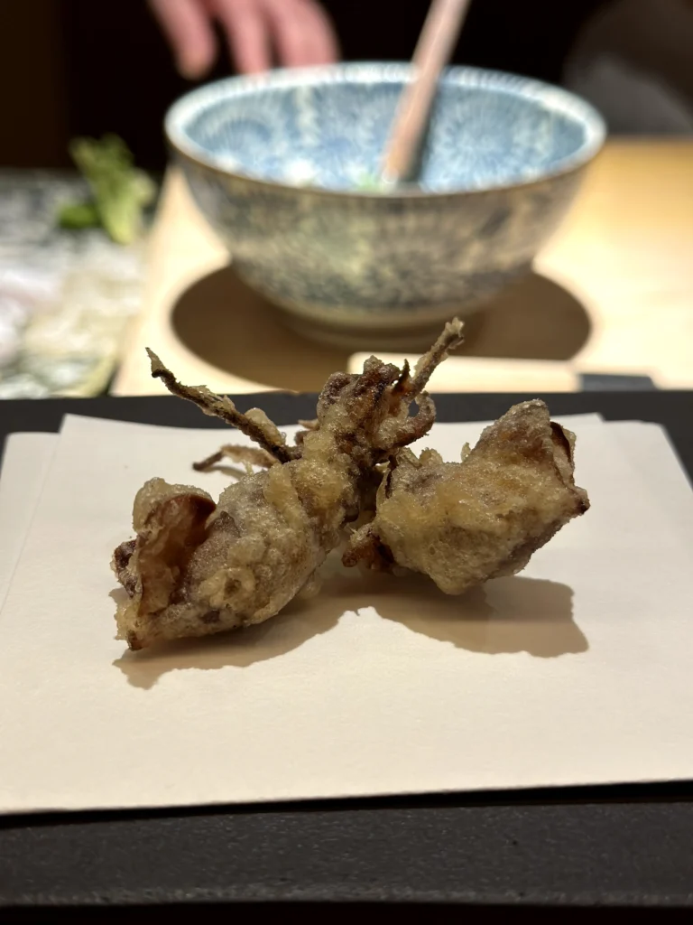 Firefly squid tempura with a crisp batter, served as a seasonal Japanese omakase specialty.