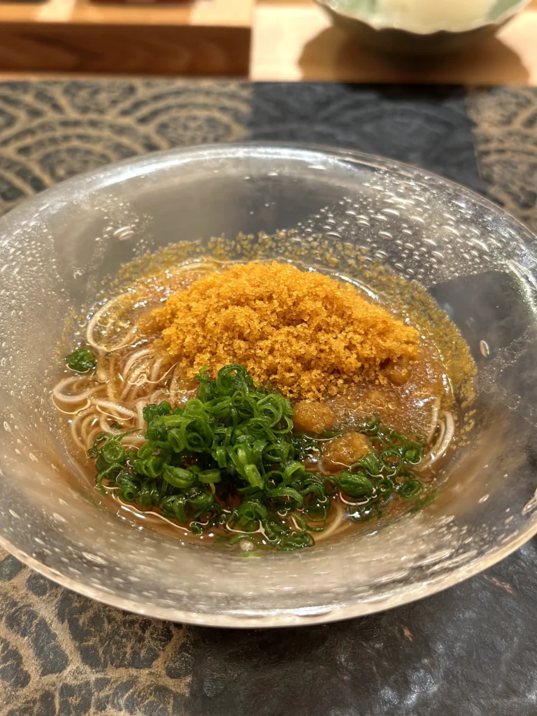 Karasumi somen noodles topped with grated bottarga and green onions in a chilled savory broth.