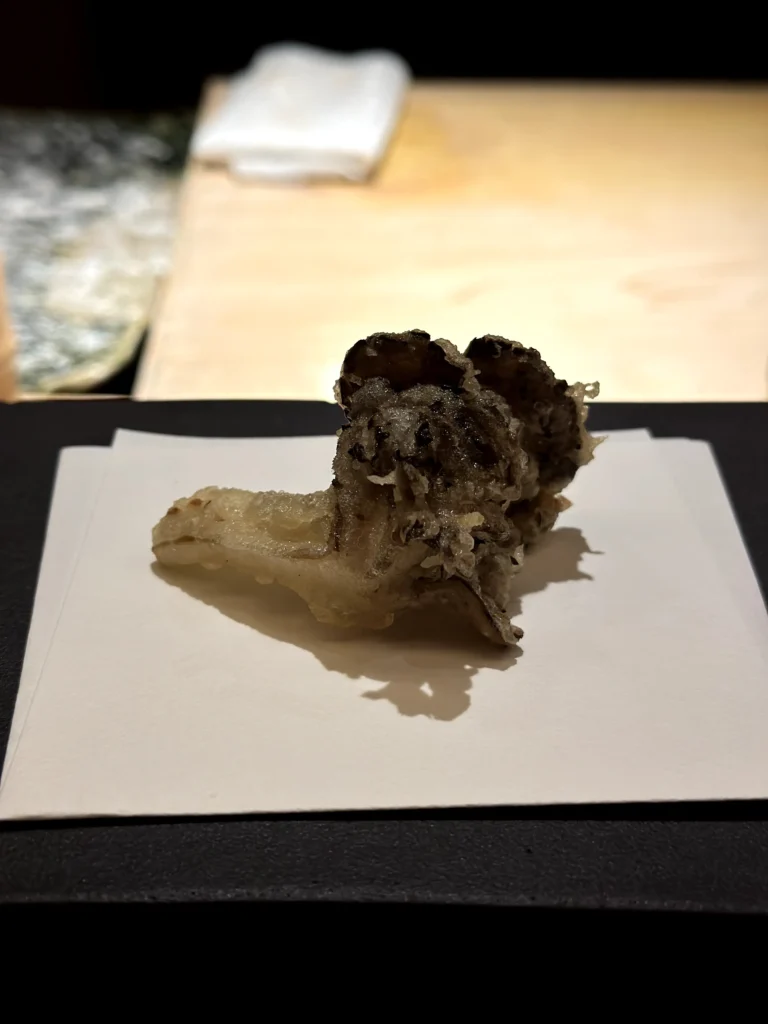 Crispy maitake mushroom tempura with an airy batter, served as part of a premium seasonal omakase course.