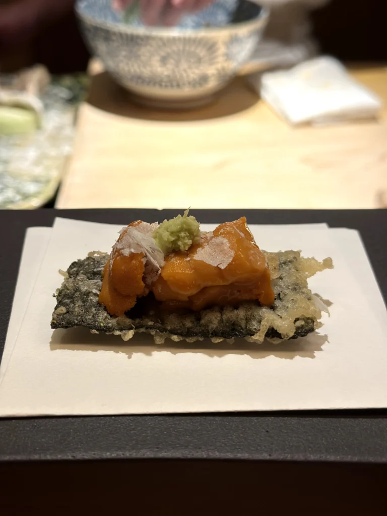 Sea urchin tempura served on a crispy seaweed tempura sheet, topped with grated daikon and fresh wasabi.